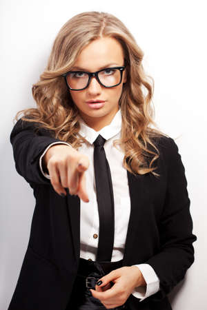 closeup seriously businesswoman portrait wearing eyeglasses showing forward with fingerの写真素材