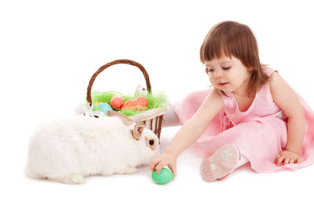 little girl playing with fur eatser rabbit over whiteの写真素材