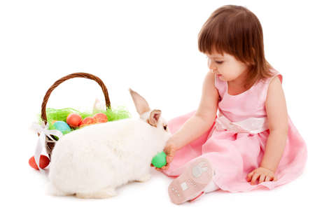 little girl playing with fur eatser rabbit over whiteの写真素材