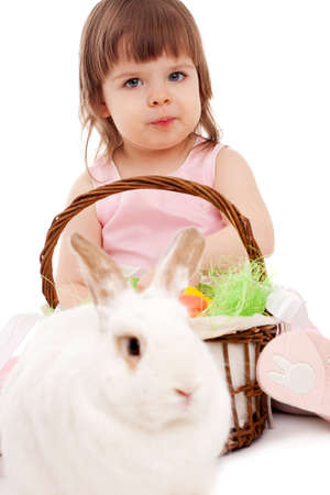 little girl playing with fur eatser rabbit over whiteの写真素材