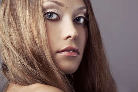 closeup beautiful woman face portrait over gray backgroundの写真素材