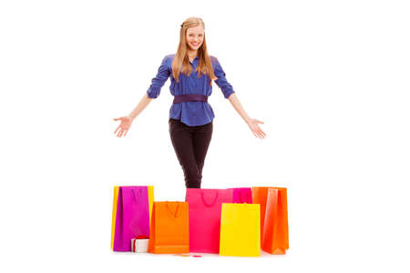 happy woman with shopping bags on the floor isolated over whiteの写真素材