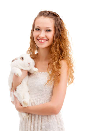 happy smiling woman holding rabbit over whiteの写真素材