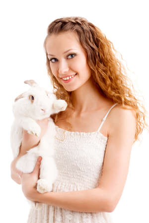 happy smiling woman holding rabbit over whiteの写真素材