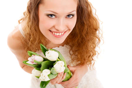 happy beautifu long haired smiling woman holding tulipsの写真素材