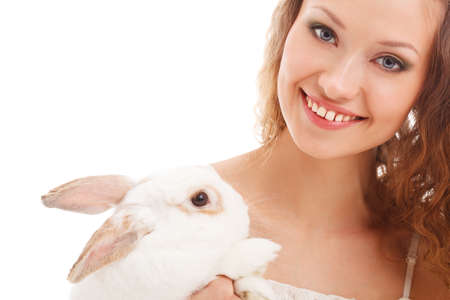 closeup happy smiling woman portrait holding rabbit over whiteの写真素材