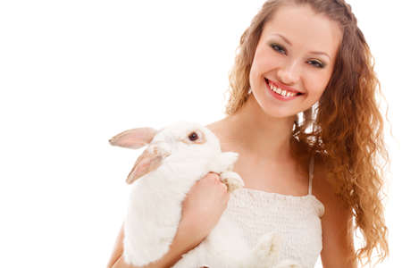 happy smiling woman holding rabbit over whiteの写真素材