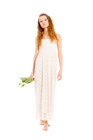 happy beautifu long haired smiling woman holding tulips, full length portraitの写真素材