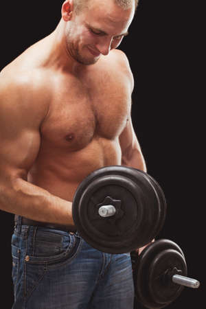 strong man excersizing with heavy dumbbellsの写真素材