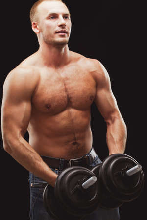 strong man excersizing with heavy dumbbellsの写真素材