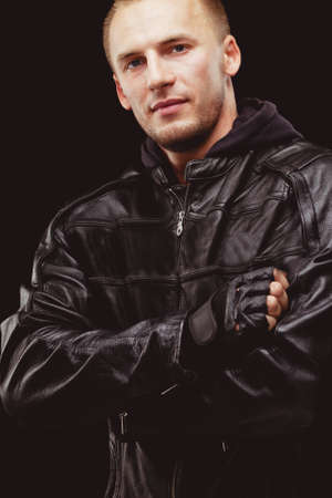 man wearing black leather jacket portrait over dark backgroundの写真素材