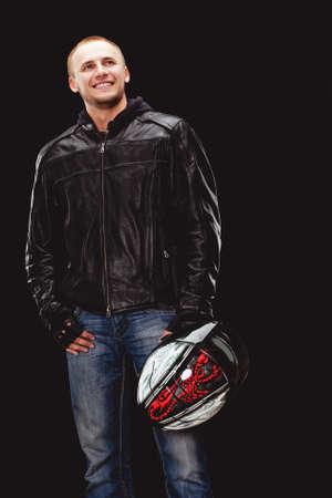 man wearing black leather jacket holding motorcycle helmetの写真素材