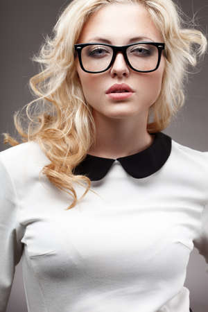portrait of blonde young beautiful woman wearing eyeglassesの写真素材
