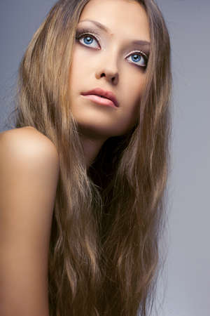 beautiful woman portrait over blue backgroundの写真素材