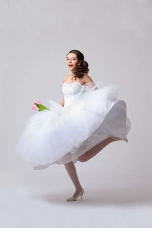beautiful bride jumping in studioの写真素材