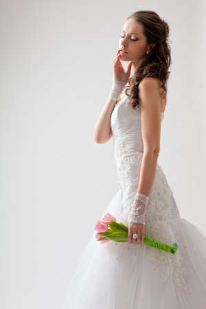 beautiful bride studio portrait with backlight, she closed her eyesの写真素材