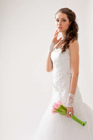 beautiful bride studio portrait with backlight, she looking at cameraの写真素材