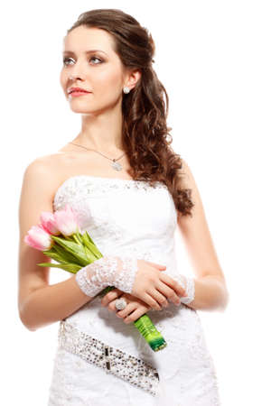 beautiful caucasian bride studio portrait with bouquet of pink tulipsの写真素材