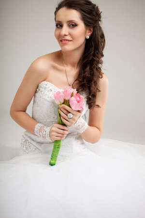 beautiful brunette  bride sitting on the floorの写真素材