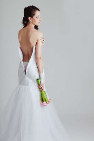 a  bride with a bare back dress over white backgroundの写真素材