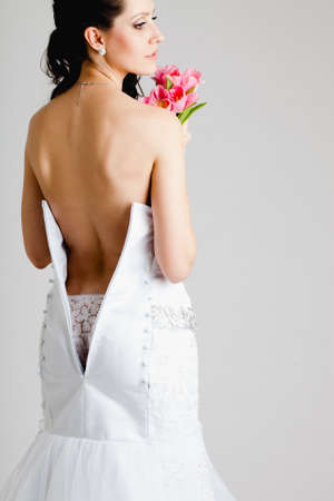a bride with a bare back dress over white backgroundの写真素材
