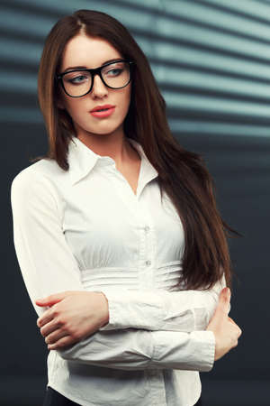 businesswoman wearing glasses in front of a striped backgroundの写真素材