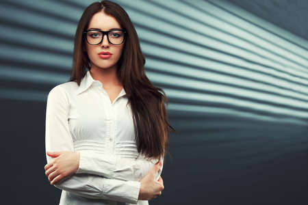 businesswoman wearing glasses in front of a striped backgroundの写真素材