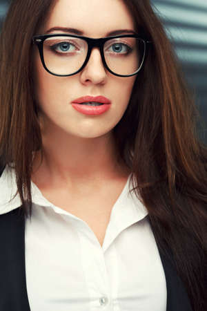 close-up portraits of a business woman on a dark striped backgroundの写真素材