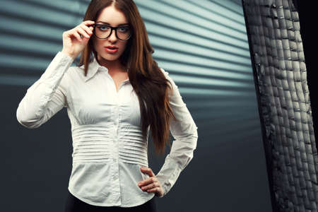 businesswoman wearing glasses in front of a striped backgroundの写真素材