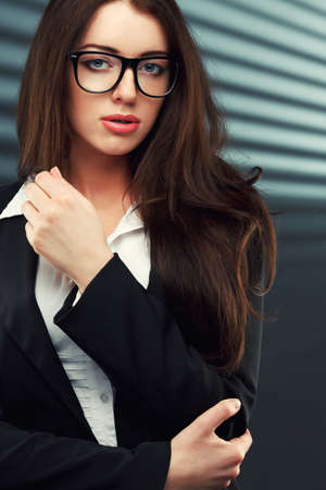 close-up portraits of a business woman on a dark striped backgroundの写真素材
