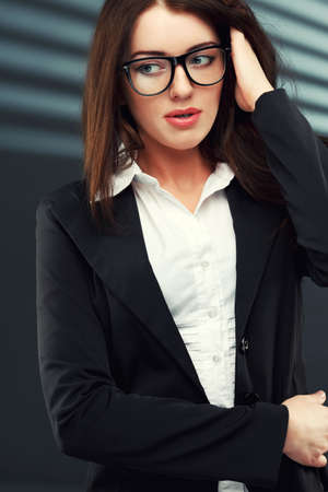 close-up portraits of a business woman on a dark striped backgroundの写真素材