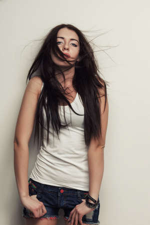 sexual woman fashion studio portrait , posing over wallの写真素材