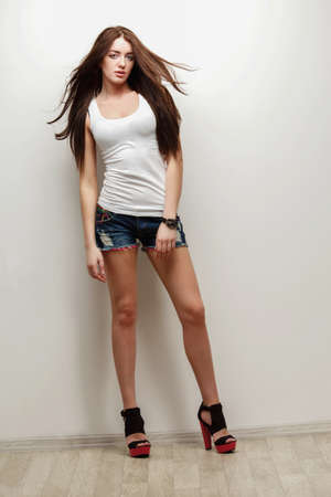 sexual woman fashion studio portrait , posing over wallの写真素材