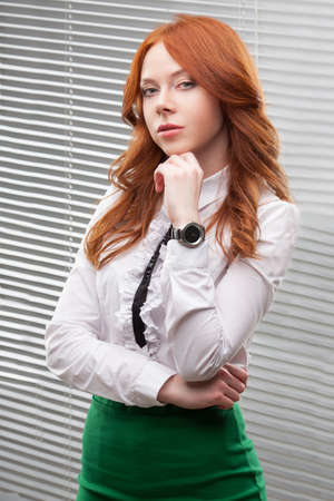 red-haired businesswoman standing over blindsの写真素材