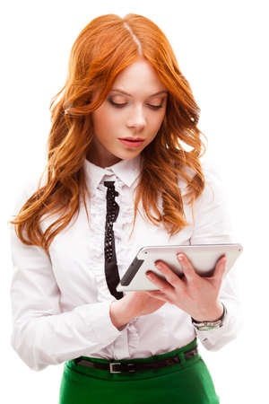 red businesswoman holding tablet isolated over whiteの写真素材