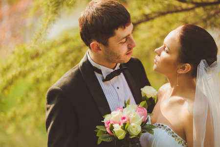 bride and groom outdoors park closeup portraitの写真素材