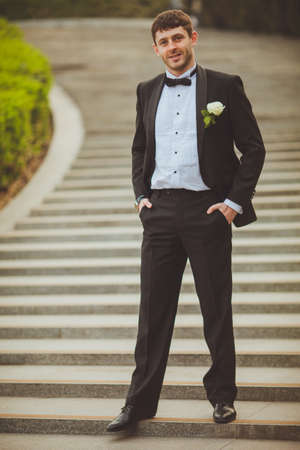 groom walking down  on staircaseの写真素材