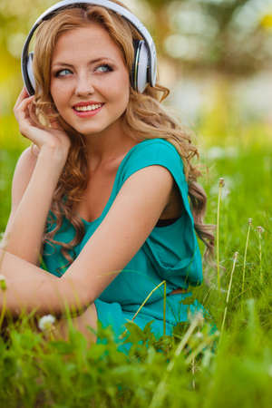 outdoors smiling portraits woman in headphonesの写真素材