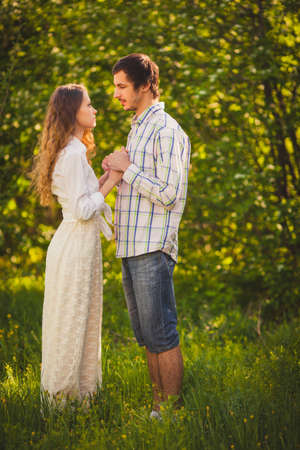 lovely happy couple looking to each other  at summer parkの写真素材