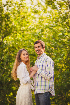 happy couple  in love looking to the camera  at summer parkの写真素材