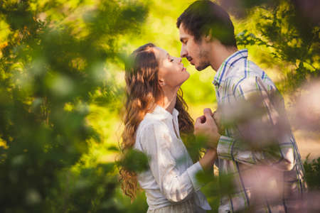 couple in love kissing in summer parkの写真素材