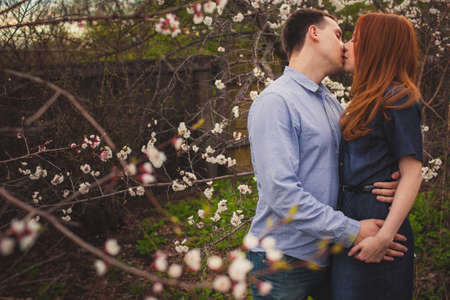 beautiful couple kissing among the flowering treesの写真素材