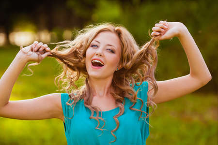 funny girl holding her hair outdoorsの写真素材