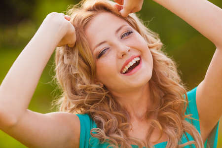 funny girl holding her hair outdoorsの写真素材