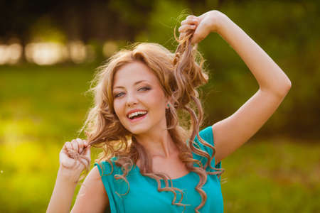 funny girl holding her hair outdoorsの写真素材