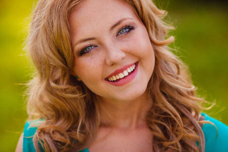 closeup happy smiling woman face outdoorsの写真素材