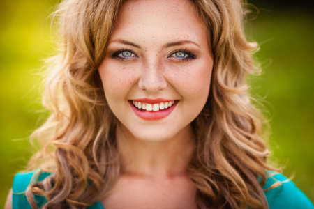 closeup happy smiling woman face outdoorsの写真素材