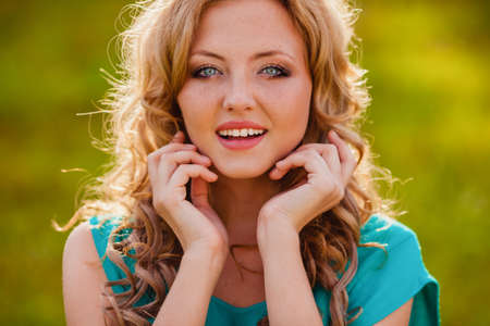 closeup happy smiling woman face outdoorsの写真素材