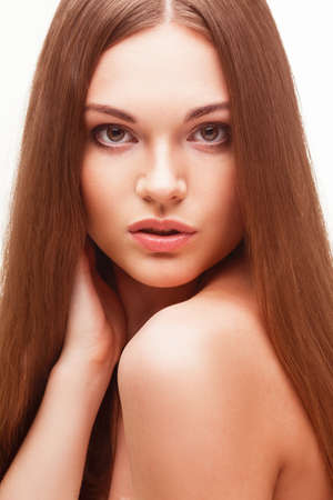 beautiful closeup woman portrait with long hair over whiteの写真素材