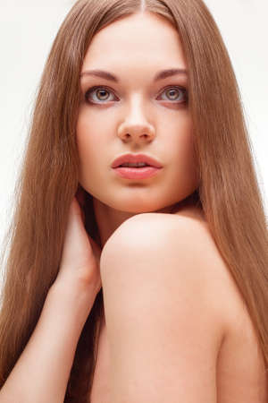 beautiful closeup woman portrait with long hair over white, looking upの写真素材